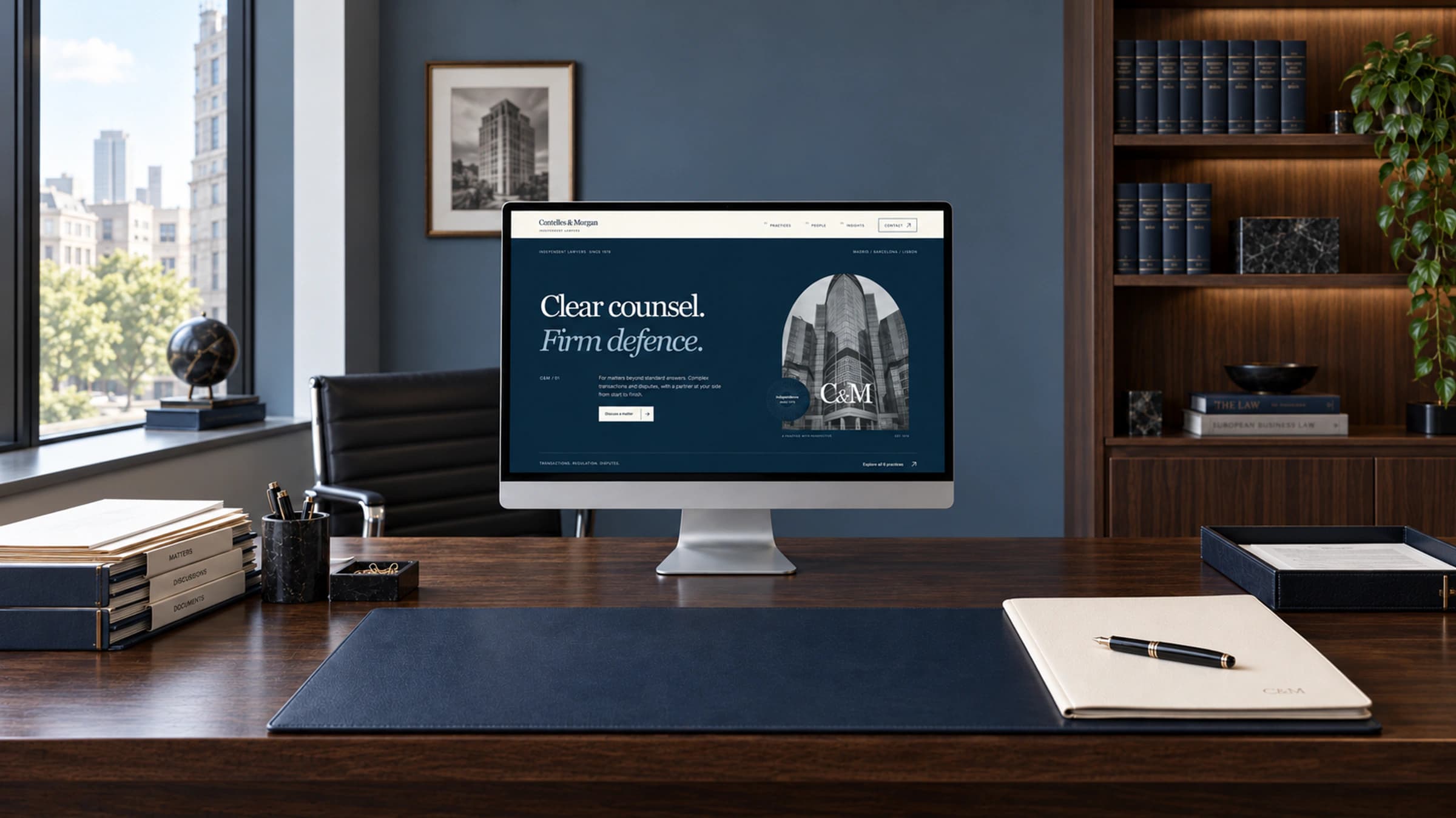 The redesigned website on a silver monitor in a walnut-lined legal office, with case files and discreet C&M stationery. An illustrative presentation, not a photograph of a real law firm.